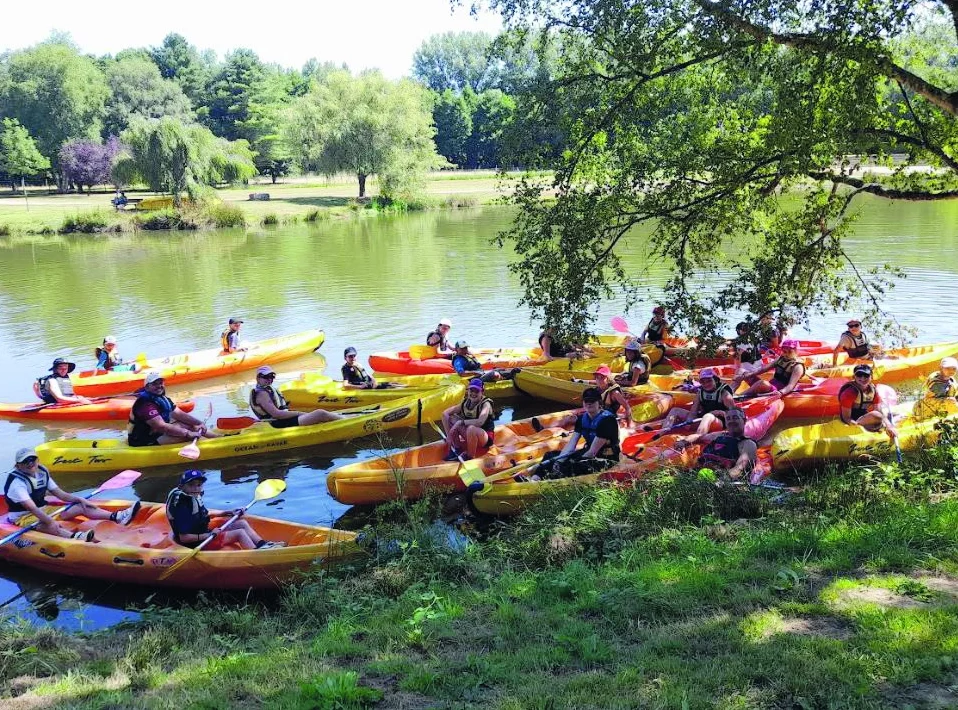 Plusieurs enfants sont dans des canoës.